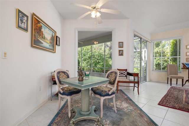 tiled dining space featuring ceiling fan