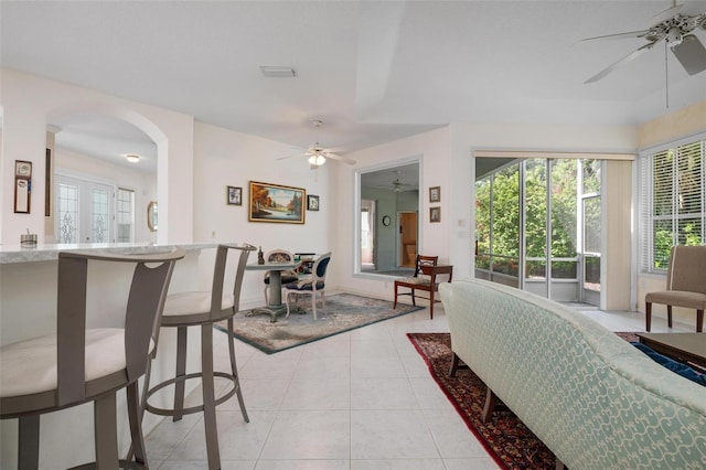 5249 Far Oak Cir, Sarasota, FL 34238 - living room featuring ceiling fan, arched walkways, and light tile patterned flooring