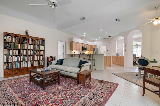 5249 Far Oak Cir, Sarasota, FL 34238 - living room featuring a ceiling fan, arched walkways, light tile patterned floors, and recessed lighting