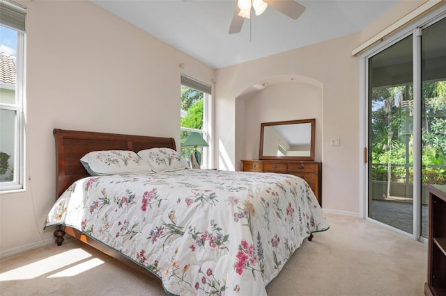 carpeted bedroom featuring vaulted ceiling, access to outside, and ceiling fan