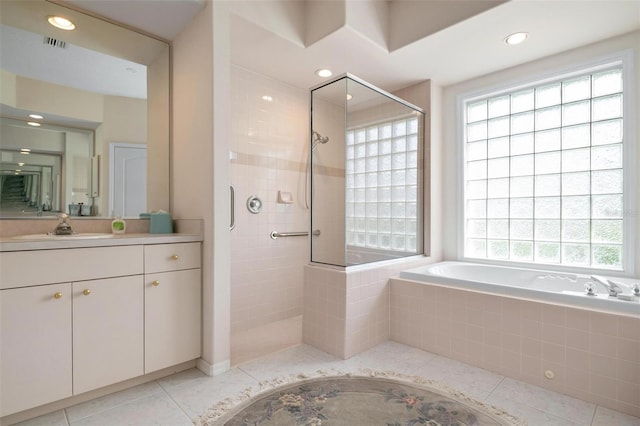 bathroom with plus walk in shower, tile patterned flooring, and plenty of natural light