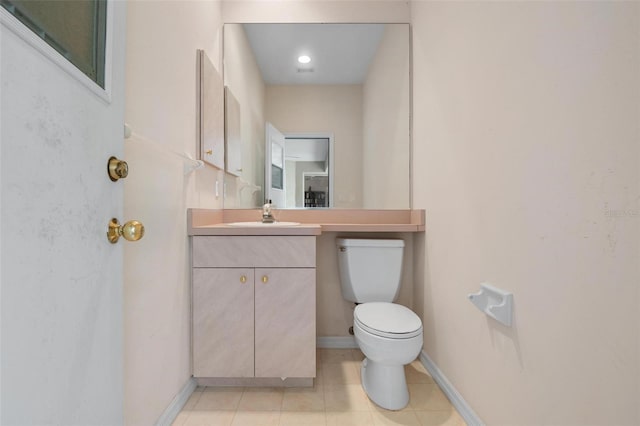 bathroom featuring vanity, tile patterned floors, and toilet