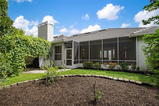 back of house featuring a sunroom