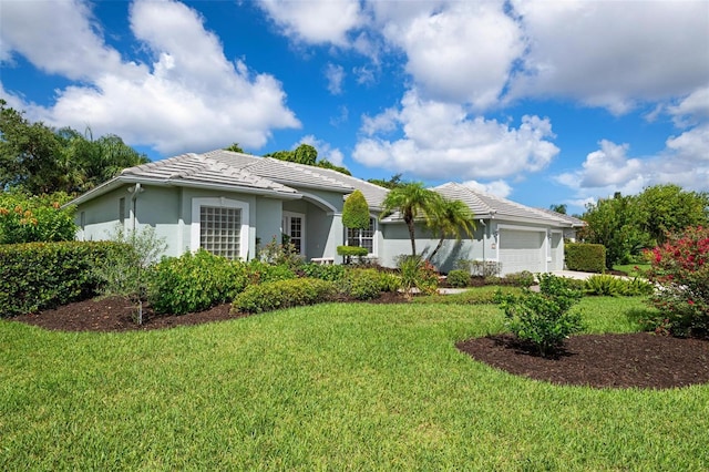 5249 Far Oak Cir, Sarasota, FL 34238 - view of front facade featuring an attached garage, a front yard, stucco siding, and a tile roof