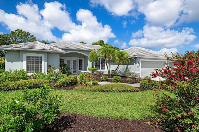 5249 Far Oak Cir, Sarasota, FL 34238 - single story home with a tiled roof, an attached garage, stucco siding, french doors, and a front yard