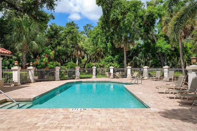 5249 Far Oak Cir, Sarasota, FL 34238 - community pool featuring view of wooded area and a patio area