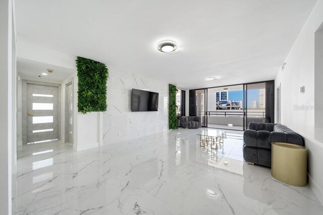 tiled living room with floor to ceiling windows