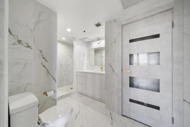 bathroom with tile walls, vanity, toilet, and walk in shower