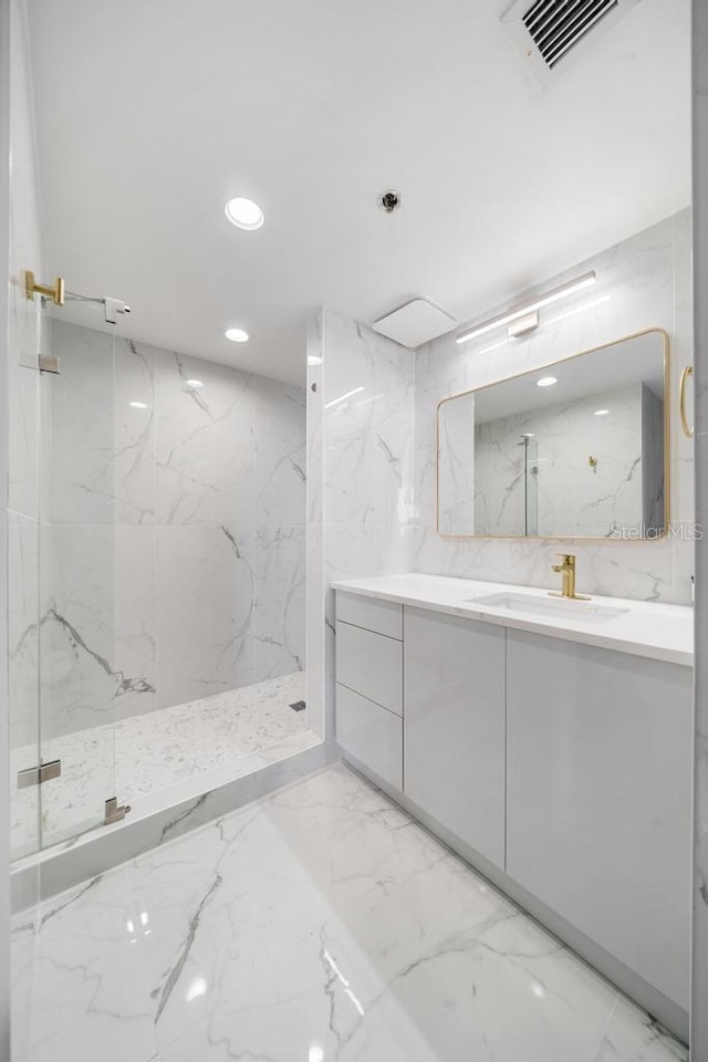 bathroom featuring vanity and tiled shower