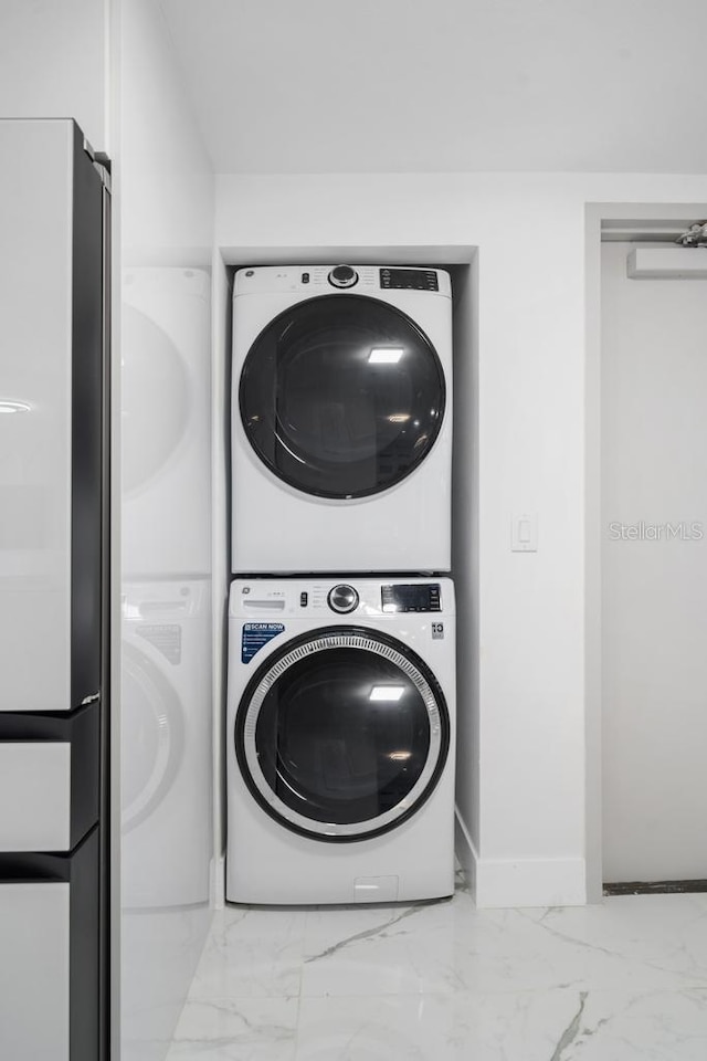 laundry room featuring stacked washer and dryer