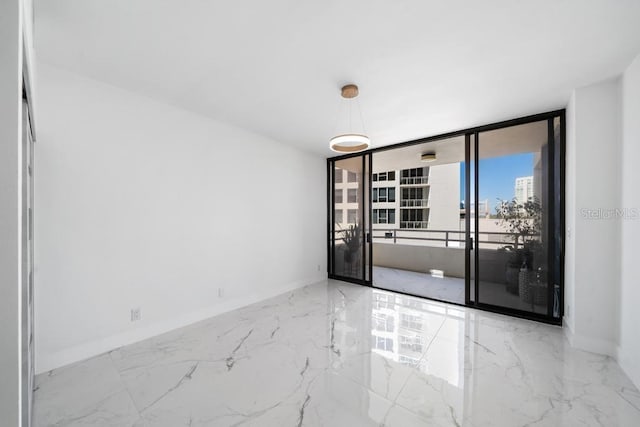 unfurnished room featuring a wall of windows