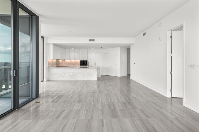 unfurnished living room featuring floor to ceiling windows