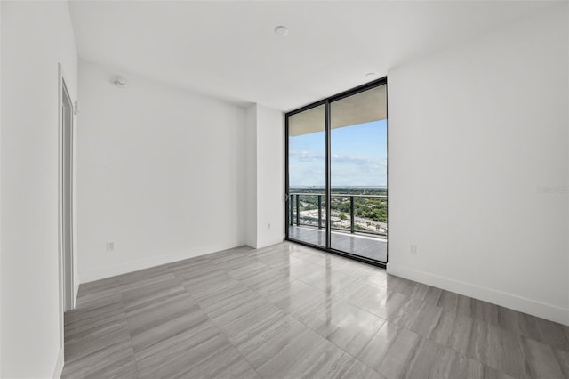 spare room with floor to ceiling windows