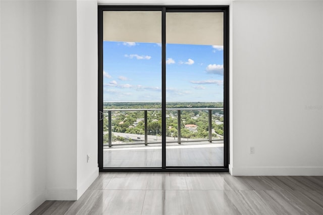 unfurnished room with floor to ceiling windows