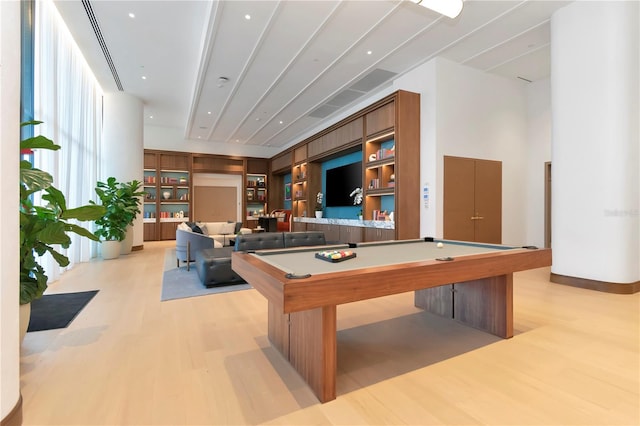 playroom with built in shelves, billiards, and light hardwood / wood-style floors