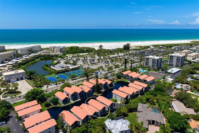 bird's eye view featuring a beach view and a water view