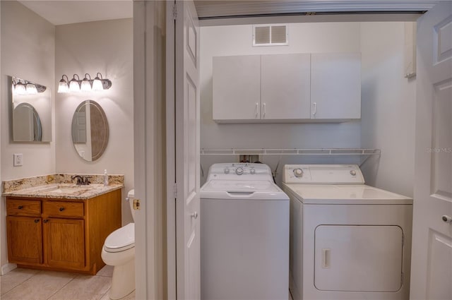 laundry room with independent washer and dryer, sink, and light tile patterned floors