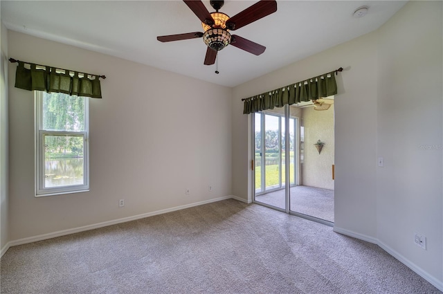 unfurnished room featuring ceiling fan and carpet flooring