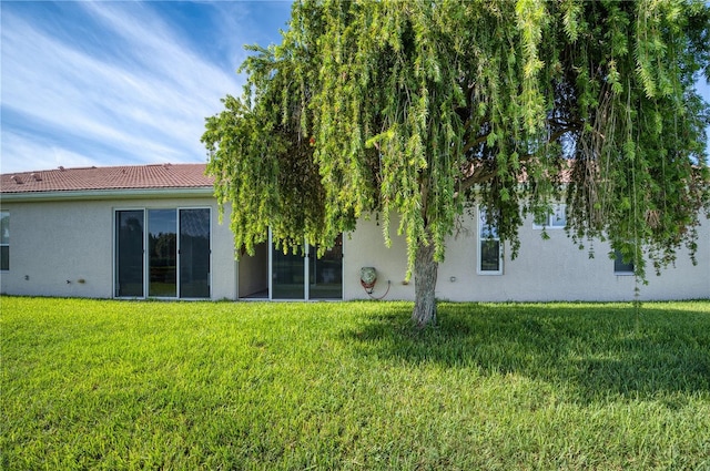 rear view of house with a lawn