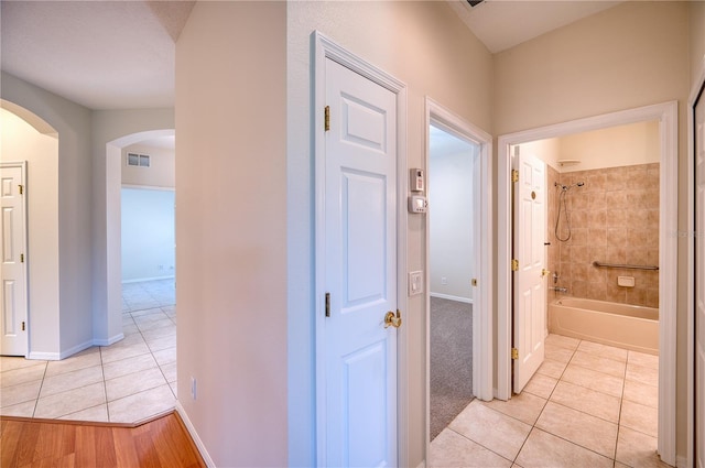 hall with light tile patterned flooring