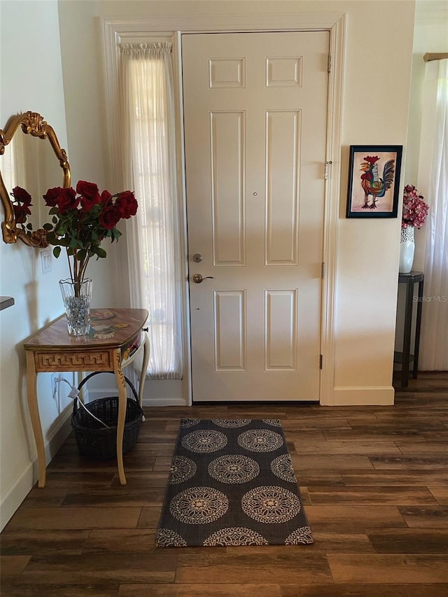 entryway featuring dark wood finished floors and baseboards