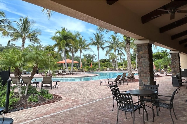 view of patio / terrace with ceiling fan and a community pool