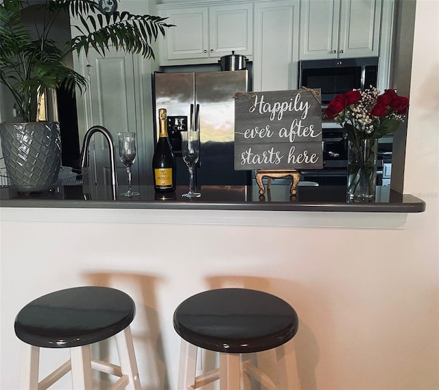 kitchen with dark countertops, appliances with stainless steel finishes, and a sink