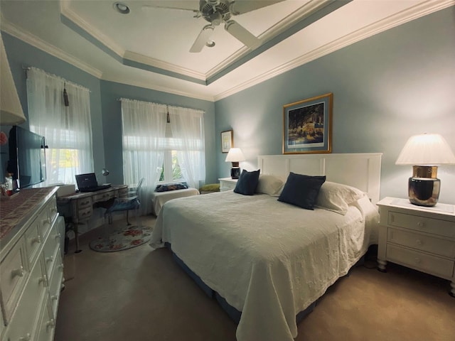 bedroom featuring carpet floors, ornamental molding, a raised ceiling, and a ceiling fan