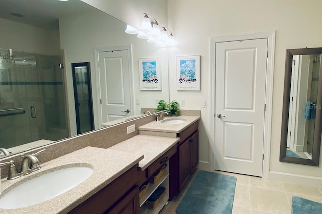 full bathroom featuring tile patterned flooring, a sink, a shower stall, and double vanity