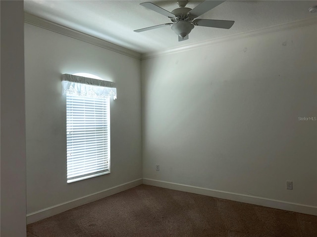 carpeted empty room featuring ornamental molding, ceiling fan, and baseboards