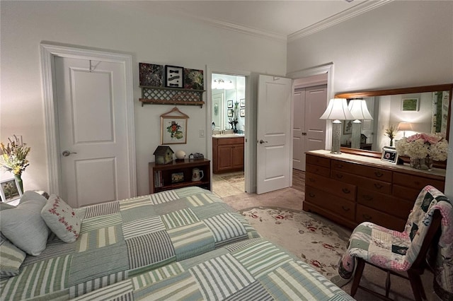 bedroom with ornamental molding, light colored carpet, and connected bathroom