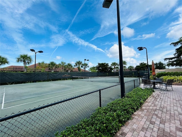 view of sport court featuring fence