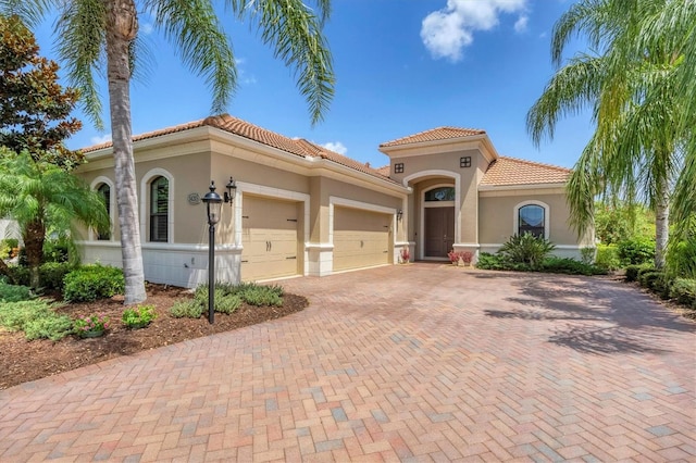 mediterranean / spanish-style home with a garage