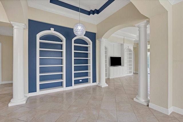 tiled entrance foyer with crown molding, a tray ceiling, and ornate columns