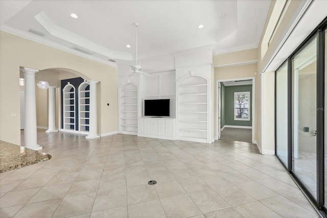 unfurnished living room with light tile patterned floors, a tray ceiling, built in features, ceiling fan, and decorative columns