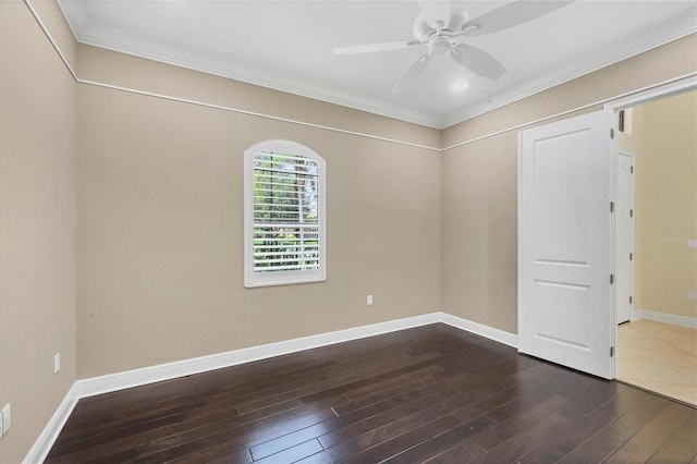 spare room with ceiling fan, ornamental molding, and dark hardwood / wood-style flooring