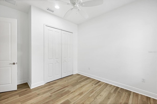 unfurnished bedroom featuring light hardwood / wood-style floors, a closet, and ceiling fan