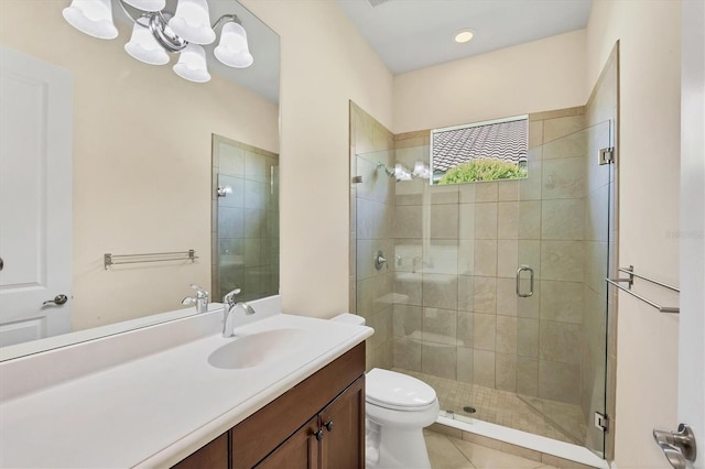 bathroom with tile patterned flooring, toilet, vanity, and a shower with shower door