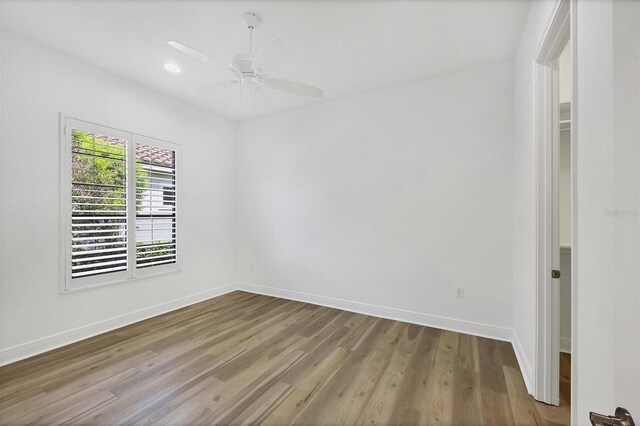 empty room featuring ceiling fan and light hardwood / wood-style floors