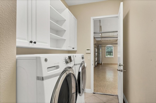 laundry area featuring light tile patterned floors and washer and dryer