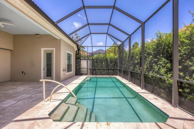 view of swimming pool featuring a patio and glass enclosure