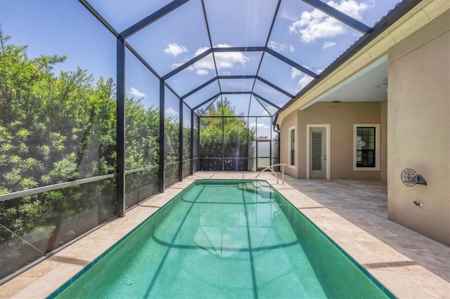 view of swimming pool with a patio and glass enclosure