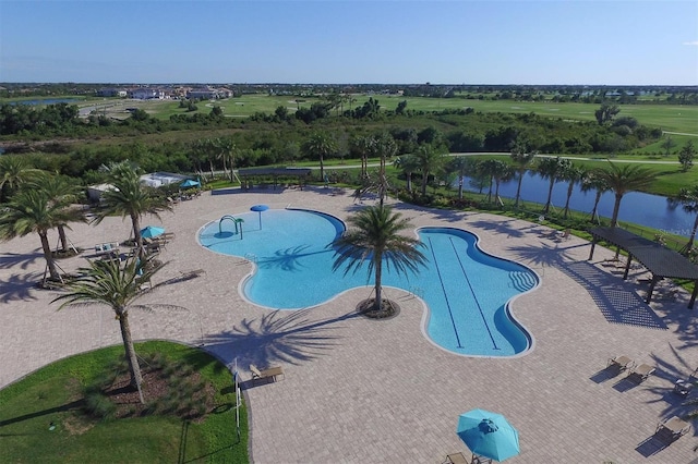 view of pool with a patio and a water view