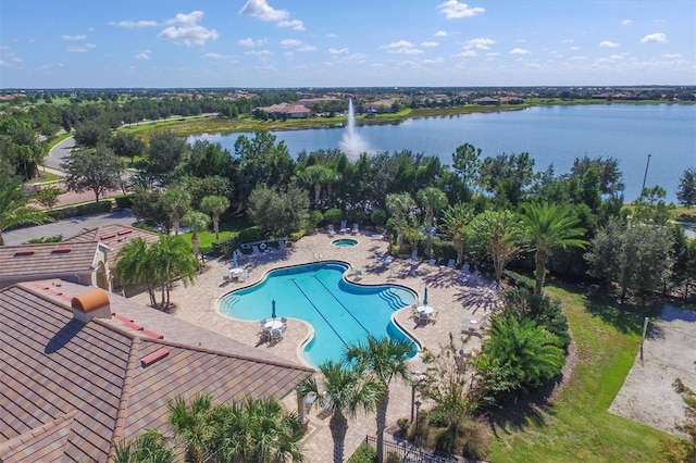 view of swimming pool with a patio area and a water view