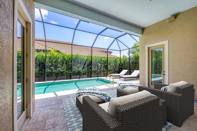 view of pool featuring a patio area, outdoor lounge area, and glass enclosure