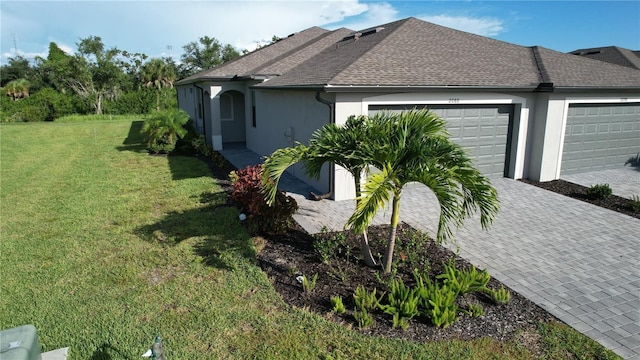 view of property exterior with a lawn and a garage