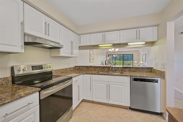 kitchen with sink, dark stone countertops, white cabinets, and stainless steel appliances