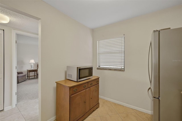 kitchen with light carpet and appliances with stainless steel finishes