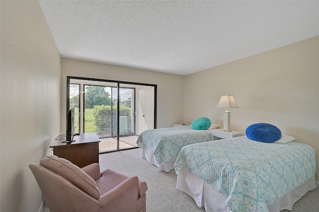 bedroom featuring access to outside, light carpet, and a textured ceiling