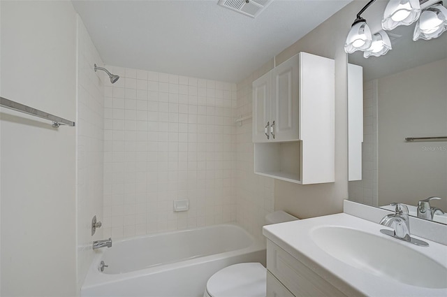 full bathroom with vanity, toilet, and tiled shower / bath